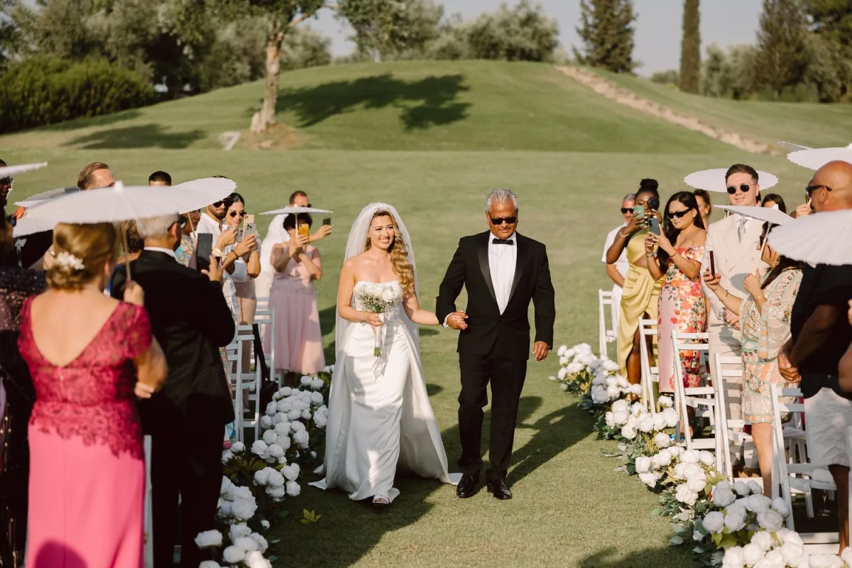 Bride walking down the aisle at an outdoor wedding ceremony in Girne, North Cyprus