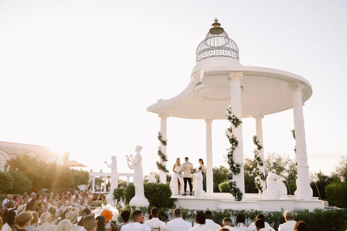 Sunset wedding ceremony under a floral gazebo at a North Cyprus resort