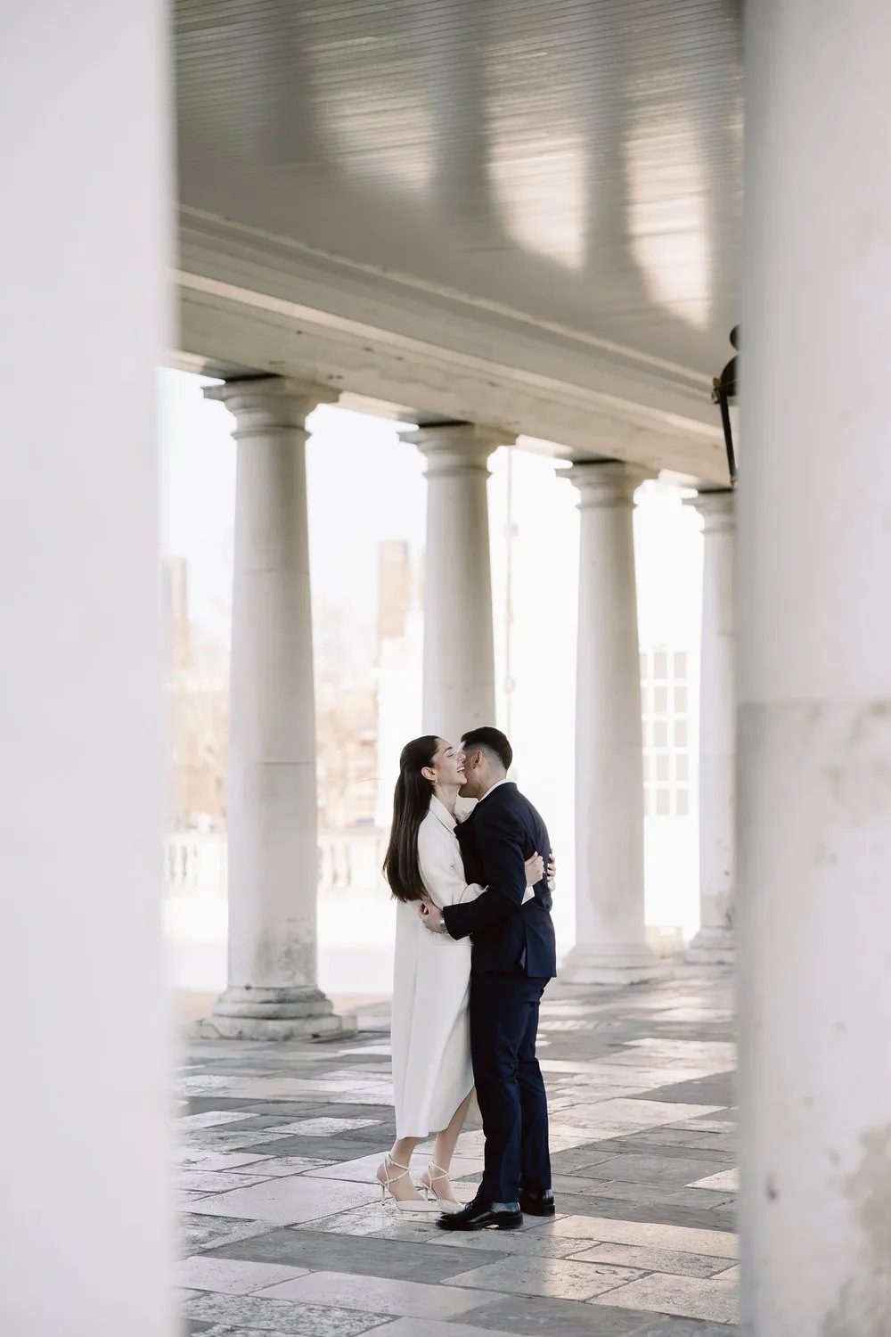 Cyprus wedding portrait beneath a historic stone colonnade
