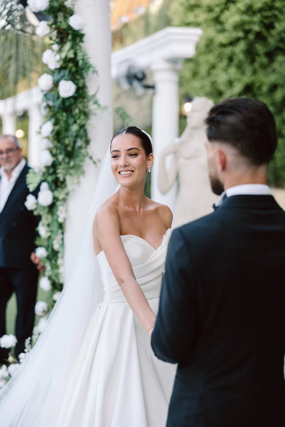 Bride laughing during an outdoor wedding ceremony in Cyprus