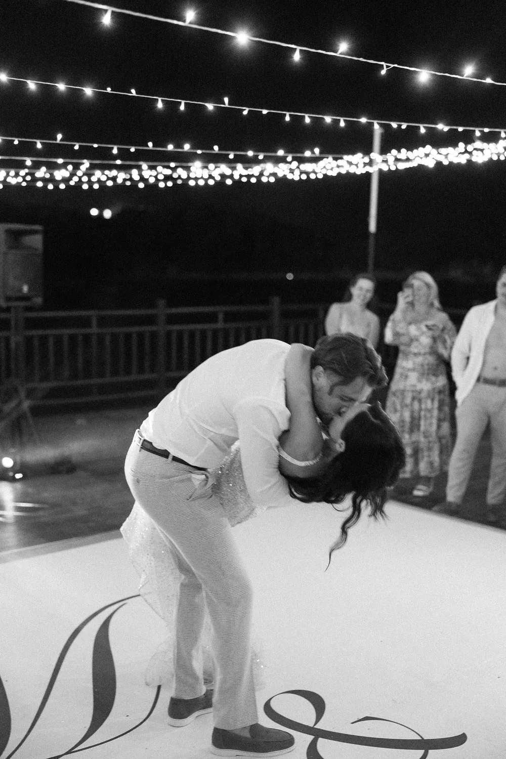 Black and white Cypriot wedding reception photography under string lights